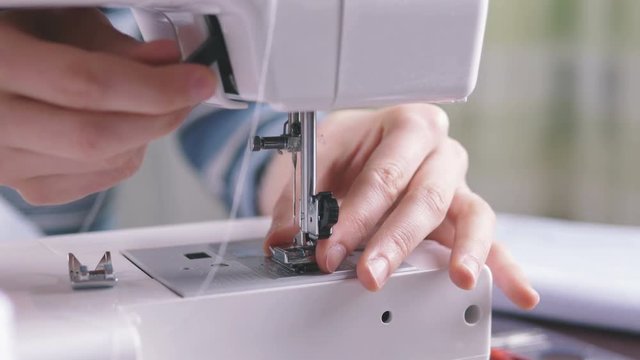 Attractive brunette female and sewing machine
