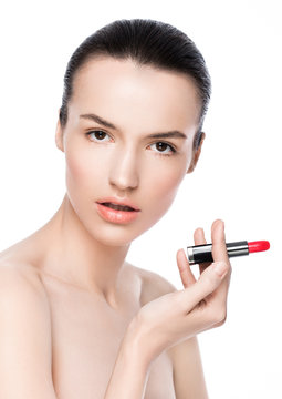Beautiful model girl holding lipstick tube makeup