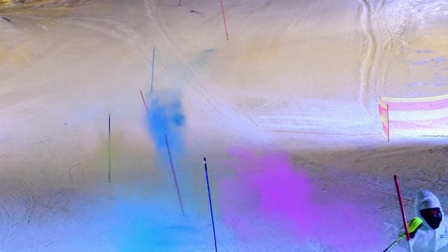 Good skier in night slalom &ndash; explosions of colors out of the goal-posts