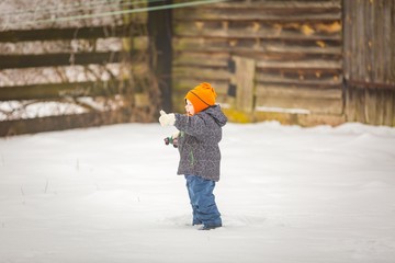 Fototapeta na wymiar Happy boy playing outdoor in winter