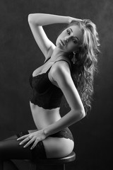 beautiful woman in lingerie posing on black background, monochrome