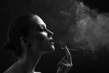 Obraz premium luxury woman smoking cigarette on black background, monochrome