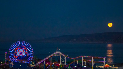 Ferris wheel and moon sets