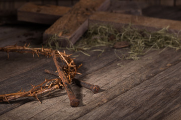 Fototapeta na wymiar Crown of Thorns and Nails on a Weathered Wooden Surface