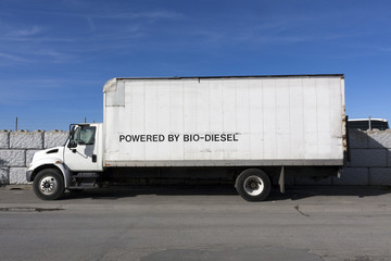 Side view of BIO-DIESEL powered truck parked under blue sky.