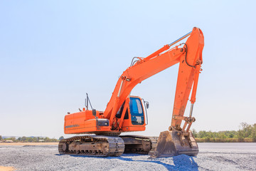 Excavators machine on a construction site on a construction site against blue sky background