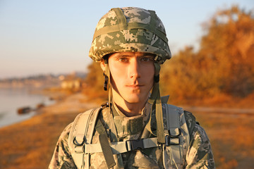 Portrait of soldier in camouflage at sunset