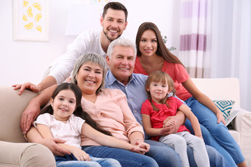 Happy family sitting on sofa in the room