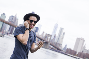 Man in Brooklyn listening music with earphones