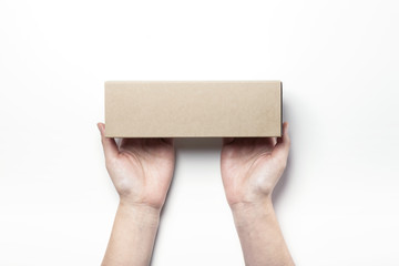 woman(female)'s hand hold a brown empty paper case isolated white.