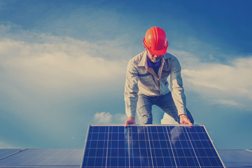 electrician working on  maintenance equipment at solar power plant; electrician swapping  solar...