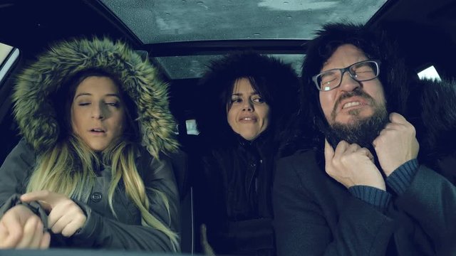 Unhappy people feeling very cold in car