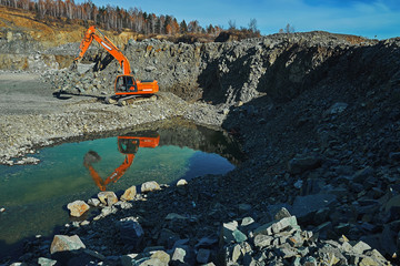 big shovel excavator standing on gravel stones © Max