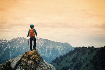 successful woman backpacker enjoy the view on mountain peak