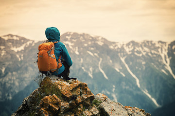 successful woman backpacker enjoy the view on mountain peak