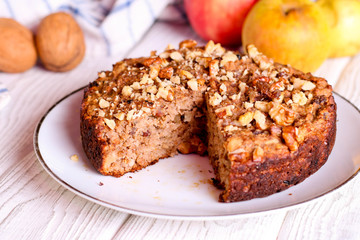 homemade apple pie with nuts on a plate, horizontal