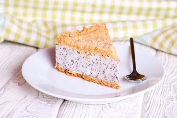 Slice of poppy seed cake on a white plate