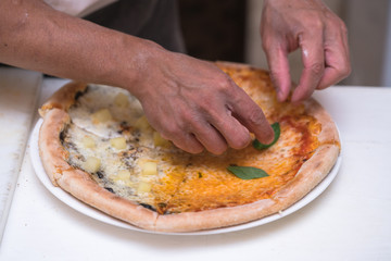 chef making pizza at kitchen