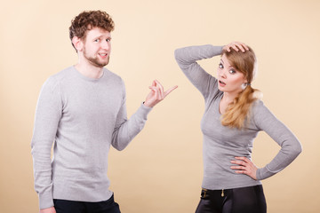 Young emotional couple arguing.