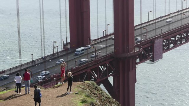 Motion timelapse of people taking pictures at the Golden gate bridge, on a sunny november day, in San Fransisco, California, United states of america