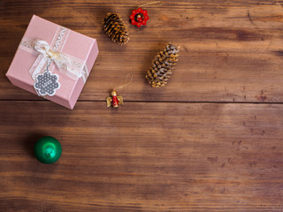 Vintage gift box, fir cones with Christmas toy on wood background with copy space for text. Top view, Studio photography