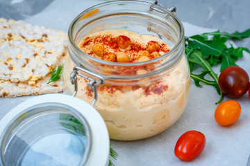 Healthy chickpea hummus in jar with vegetables. Clean eating, vegetarian, raw, detox, dieting concept