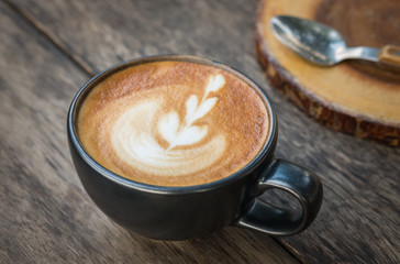Cup of coffee art on wooden table