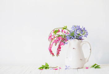 flowers in jug on white background