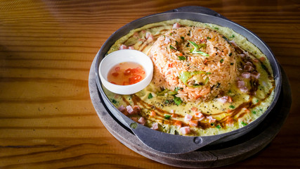 spicy fried rice ( Tom Yum ) seafood with mixed vegetable and cheese  in cast iron pan spicy taste at Thai styled food