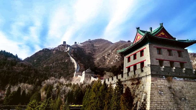 The Great Wall of China with a tower on the mountain under clear sky