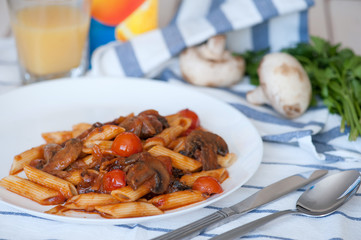Penne pasta with tomato sauce and mushrooms