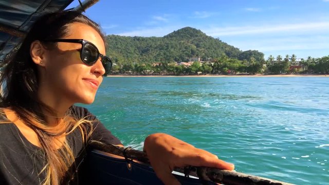 Beautiful Young Smiling Caucasian Woman Sails on a Wooden Thai Boat. Krabi, Thailand.