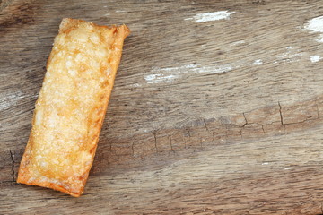 The crispy pie put on the hard wood surface represent the pastry and dessert concept related idea.