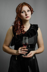 red-haired girl with a glass of wine in hand