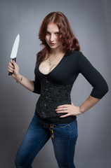 red-haired girl holding a knife