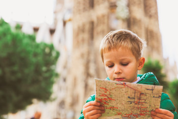 spain travel - little boy looking at map in Barcelona