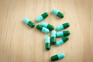 Pill on wooden table,Tablets and capsules on wooden table 
