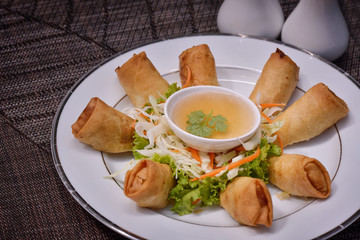 Deep fried spring rolls on white dish