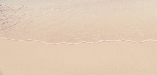 Fototapeta na wymiar Soft wave of the sea on the sandy beach
