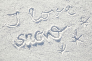 Inscription I love snow in the fresh snow in sunny winter day.