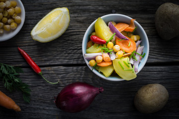 Top View Vegetable Salad with Chickpea on Dark Wood Background