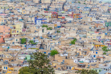 Photo of a Urfa taken from the city castle. Only houses and one tree compose the picture.