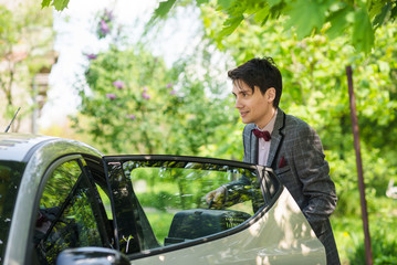 man in suit outdoor near the car