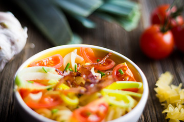Pasta with Cherry Tomatoes, Garlic and Leek Detail on Wooden Background