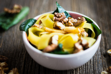 Pasta with Walnuts and Fresh Spinach Leaves. Food Detail.