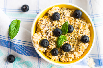 Porridge - Oat Flakes with Blueberries and Mint Leaves on Tablecloth