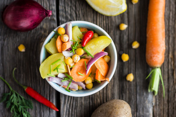 Top View Vegetable Salad with Chickpea on Dark Wooden Background