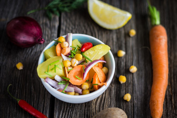 Vegetable Salad with Chickpea on Dark Wooden Background