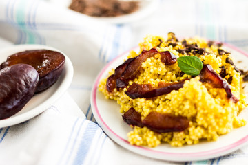 Puree of Millet Grains with Plums, Chocolate and Walnuts and Raw Ingredients on Light Tablecloth Background.