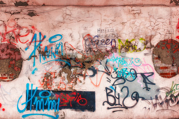 Wall and graffiti. Unreadable inscriptions in different colors